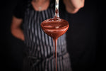 Indulgent melting chocolate by chocolatier with large spoon. Decadent milk and dark chocolate to elvate your experience